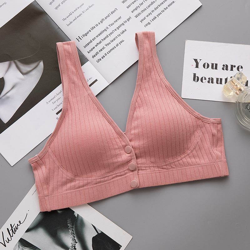 Maternity breastfeeding bra in pink with ribbed design, cotton material, and button front.