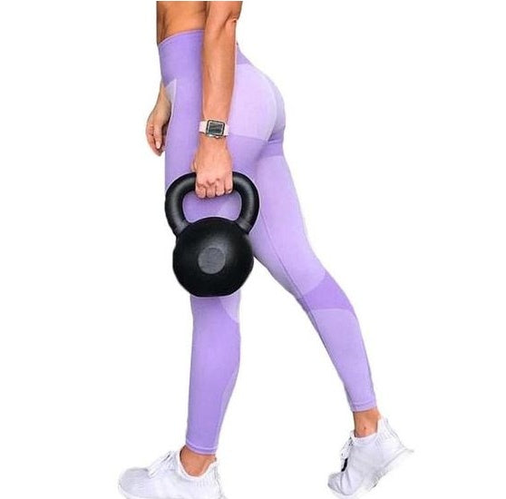 Purple Clarke Leggings worn by person holding kettlebell, featuring a comfortable and stylish fit with white sneakers.