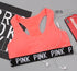 Training Pro Women Sports Bra in pink with black band, earphones, and phone.