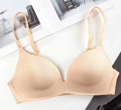 Seamless beige push-up bra made of nylon fabric.