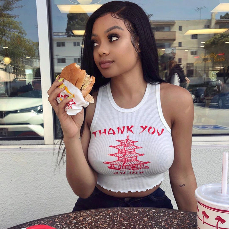 Woman wearing Yellow Crane Tower vest top with round neck eating outdoors.