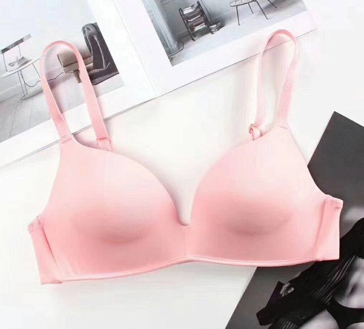 Pink seamless push-up bra for women on display.