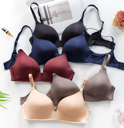 Seamless push-up bras in various colors displayed on a table.