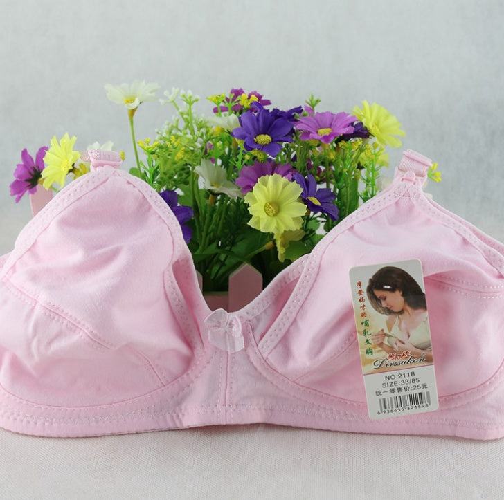 Cotton nursing bra for pregnant women in fleshy pink color, displayed with flowers.