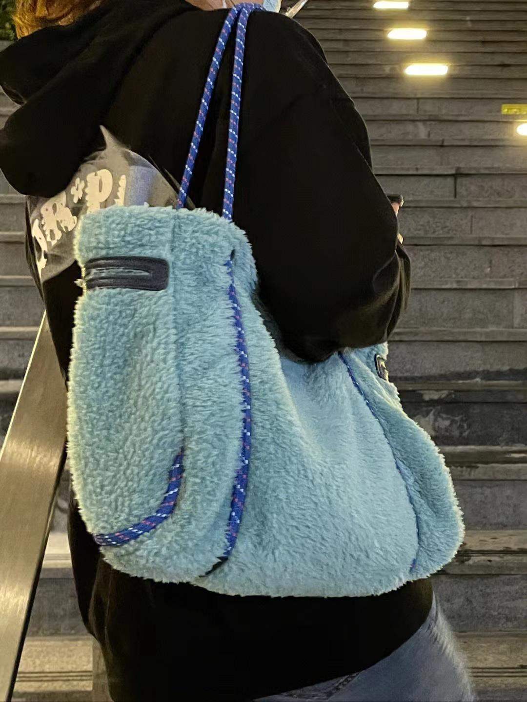 Gingerbread Man large capacity blue lamb wool shoulder bag on model, polyester, street trend style.