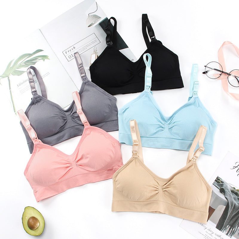 Unwired push up nursing bras in various colors including beige, pink, blue, black, displayed on a flat surface.