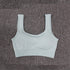 Seamless fitness bra for women on a textured background.