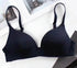 Seamless black nylon push-up bra for women displayed on a white surface.