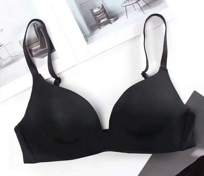 Black seamless push-up bra for women made of nylon on a white surface.