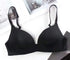 Black seamless push-up bra for women made of nylon on a white surface.