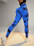 Hollow Tie Dye Printed Yoga Pants in blue with high waist, seamless butt lift design, worn in a fitness setting.