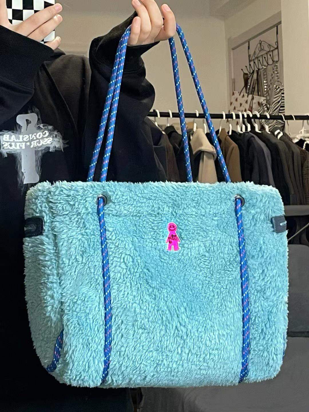 Blue lamb wool shoulder bag with large capacity and gingerbread man design.