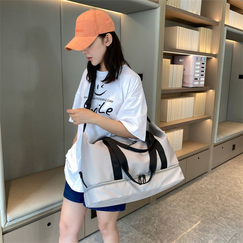 Woman holding a white waterproof sports gym bag with a shoes compartment, made of oxford cloth.