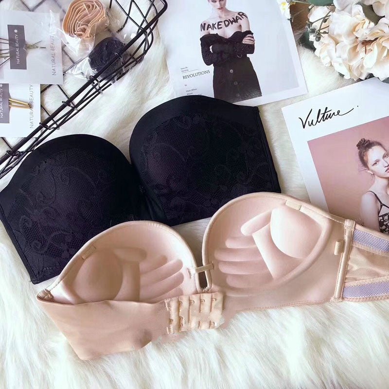 Strapless invisible bra with lace design and embroidery, featuring a thin top and thick bottom mold cup, shown in black and beige colors.